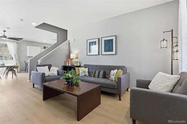a living room with furniture and wooden floor