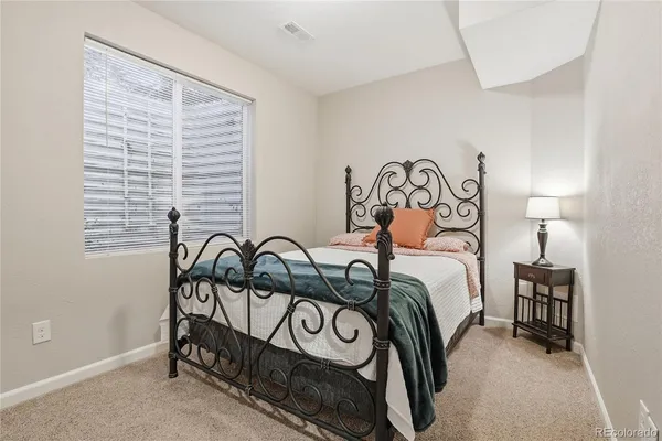 a bedroom with a bed and a table in it