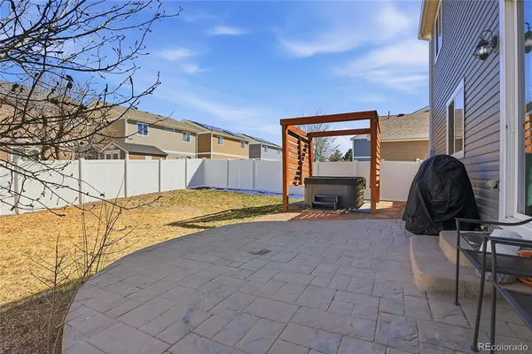 a view of a house with a large tree and wooden fence