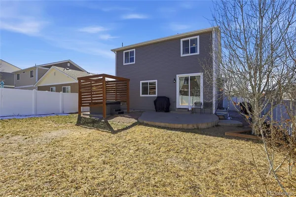 a view of a house with backyard and sitting area