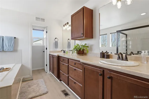 a spacious bathroom with a double vanity sink mirror and