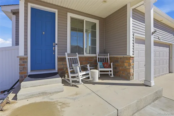 a balcony with table and chairs