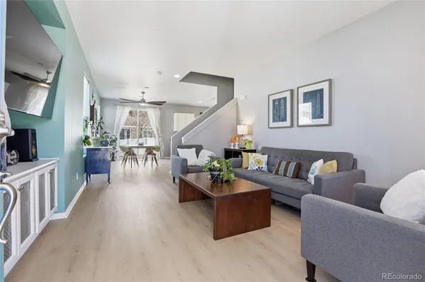 a living room with furniture and a wooden floor