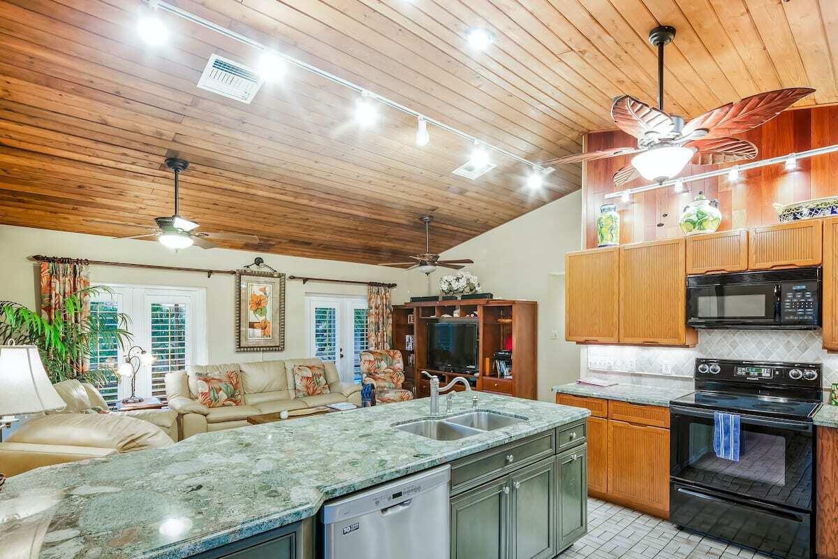 1495 Copa D Oro Marathon, FL 33050 - Photo 11 of 41 a kitchen with stainless steel appliances granite countertop a sink and wooden cabinets