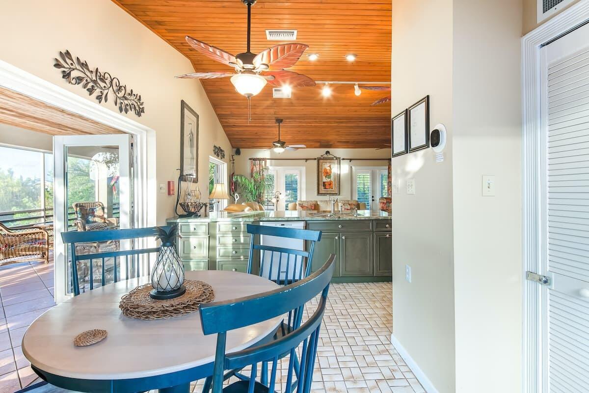 1495 Copa D Oro Marathon, FL 33050 - Photo 12 of 41 a dining room with furniture a chandelier and wooden floor