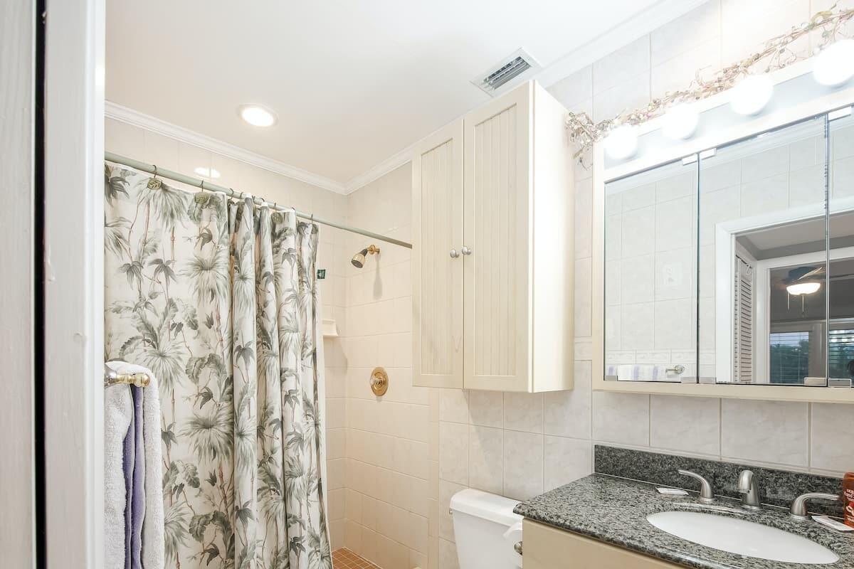 1495 Copa D Oro Marathon, FL 33050 - Photo 24 of 41 a bathroom with a granite countertop sink a mirror a vanity and shower