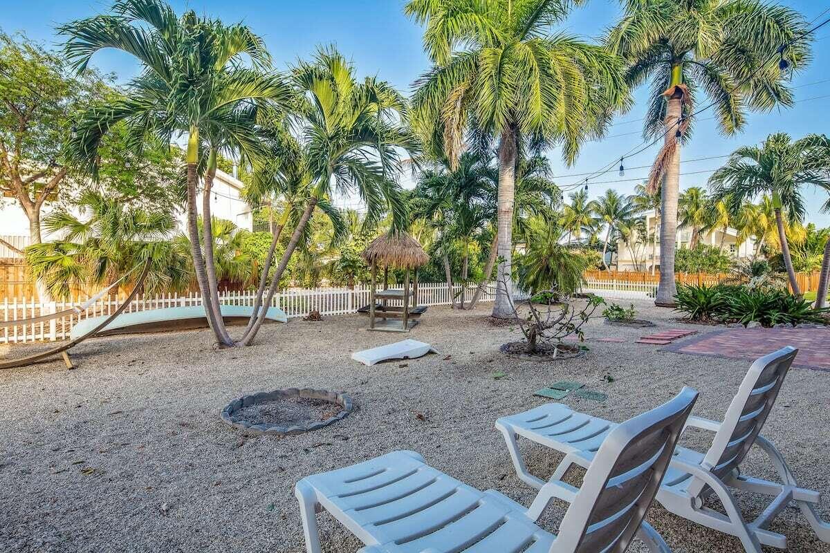 1495 Copa D Oro Marathon, FL 33050 - Photo 31 of 41 a row of palm trees sitting in a yard