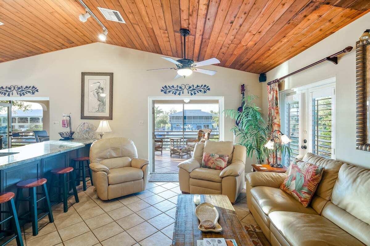 1495 Copa D Oro Marathon, FL 33050 - Photo 9 of 41 a living room with furniture a fireplace and a chandelier