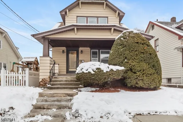 a view of a white house with large windows