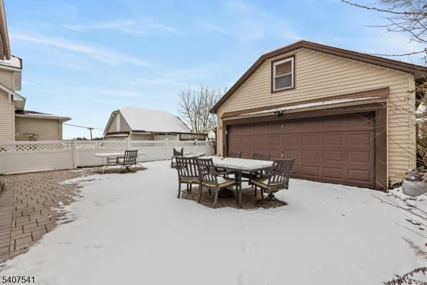 a backyard of a house with table and chairs