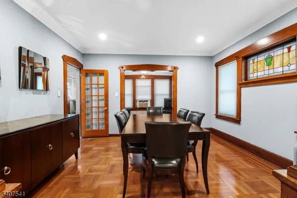 a view of a dining room with furniture a rug and wooden floor