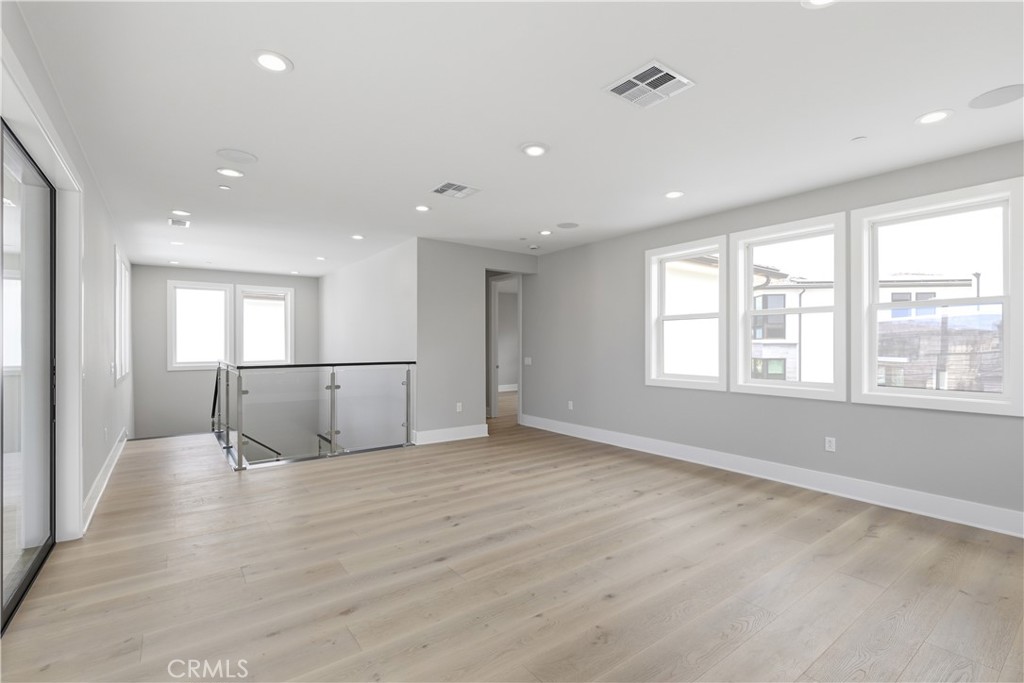 156 Apron Irvine, CA 92618 - Photo 36 of 40 a view of empty room with wooden floor and fan