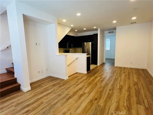 a view of kitchen with cabinets and wooden floor