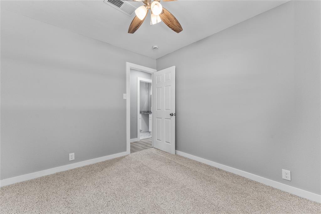 709 North Rita Street Lacy-Lakeview, TX 76705 - Photo 12 of 32 an empty room with a chandelier fan