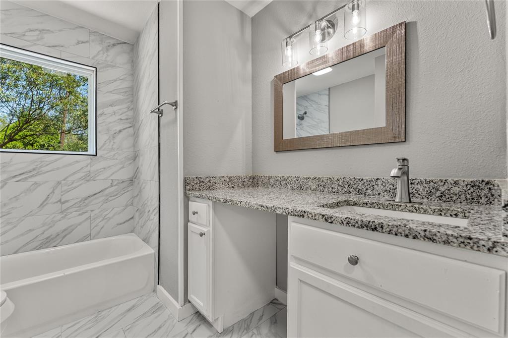 709 North Rita Street Lacy-Lakeview, TX 76705 - Photo 18 of 32 a bathroom with a granite countertop sink mirror vanity and bathtub