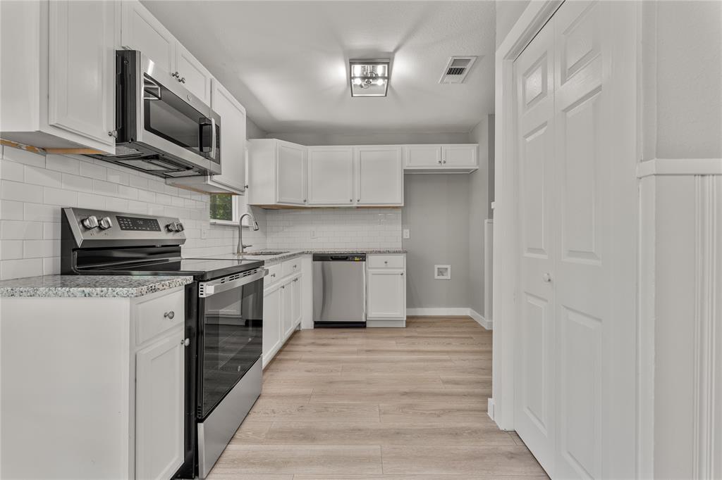 709 North Rita Street Lacy-Lakeview, TX 76705 - Photo 21 of 32 a kitchen with stainless steel appliances granite countertop a refrigerator a stove top oven a sink and dishwasher