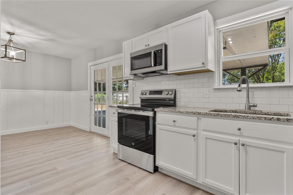 709 North Rita Street Lacy-Lakeview, TX 76705 - Photo 24 of 32 a kitchen with stainless steel appliances granite countertop a stove a sink and a microwave