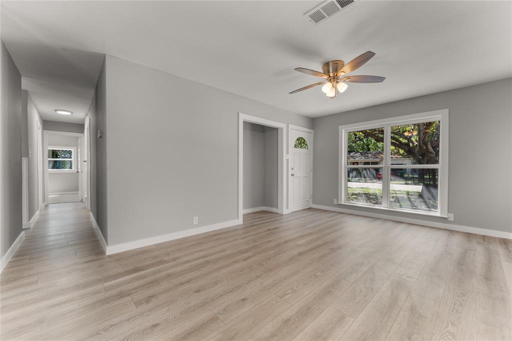 709 North Rita Street Lacy-Lakeview, TX 76705 - Photo 9 of 32 a view of an empty room with wooden floor and a window