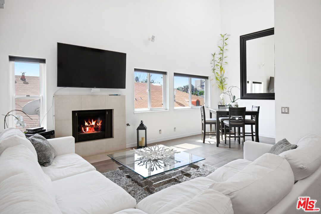 432 South Hamel Road, Unit 302 Los Angeles, CA 90048 - Photo 5 of 20 a living room with furniture a flat screen tv and a fireplace