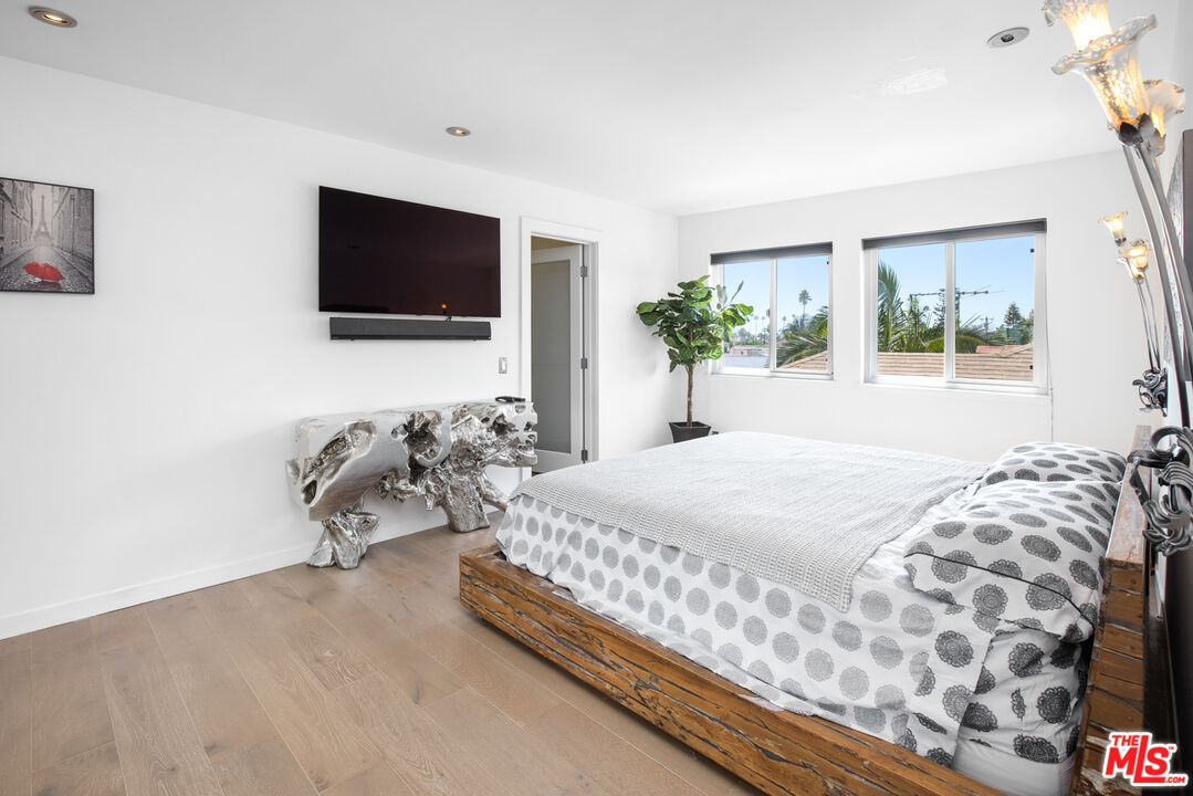432 South Hamel Road, Unit 302 Los Angeles, CA 90048 - Photo 9 of 20 a bedroom with a bed and a flat screen tv