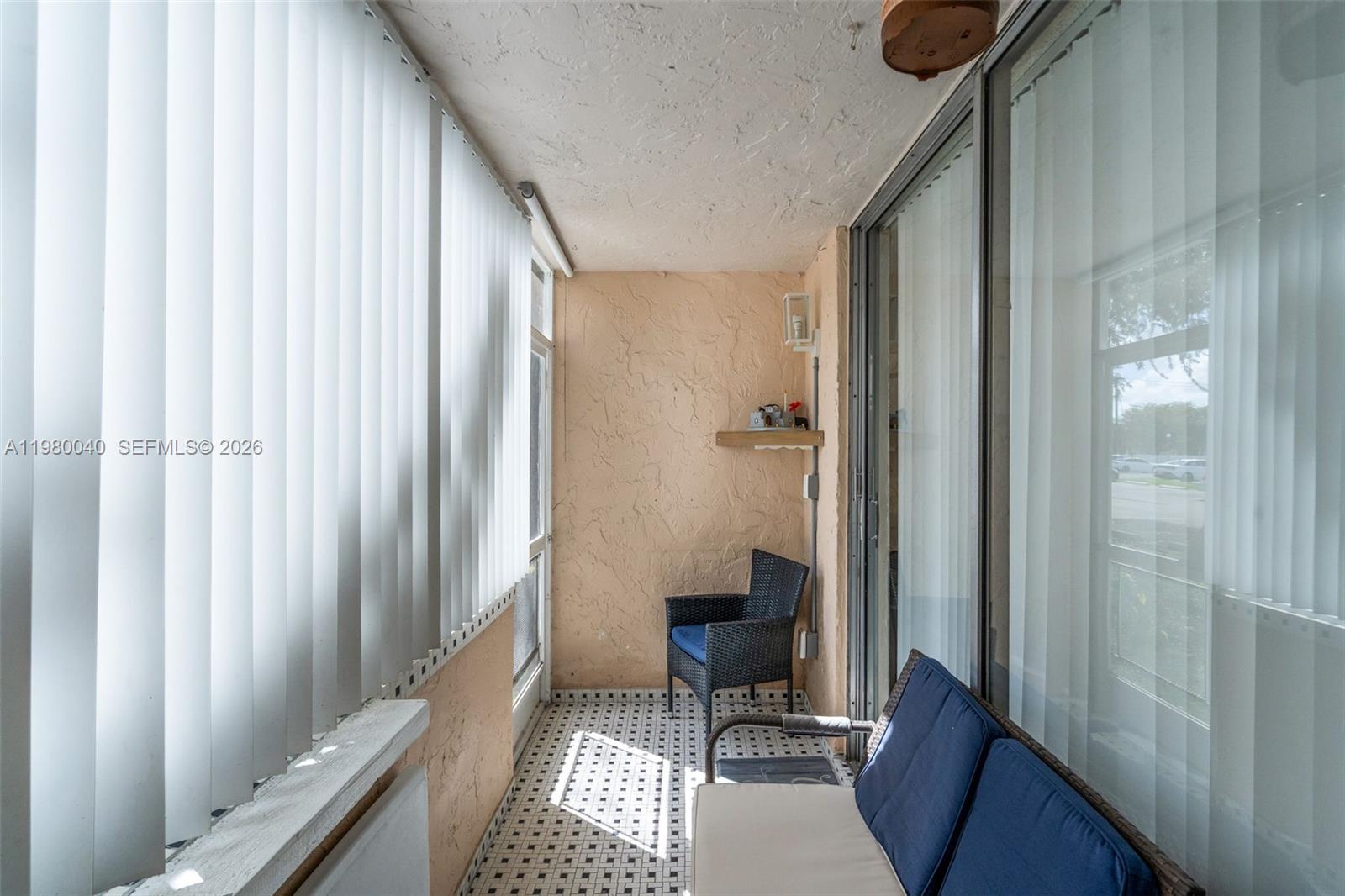 8405 Northwest 8th Street, Unit 1072 Miami, FL 33126 - Photo 14 of 33 a view of a hallway with a chair and a window