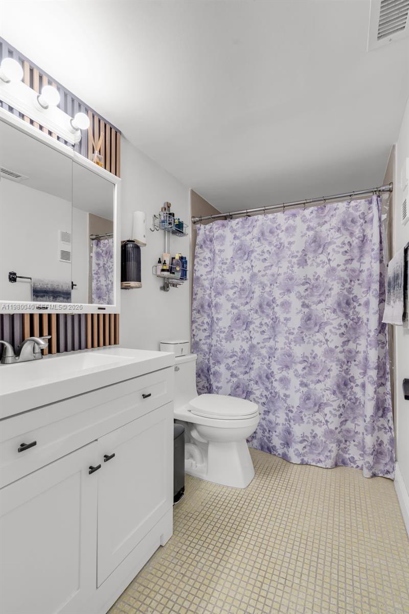 8405 Northwest 8th Street, Unit 1072 Miami, FL 33126 - Photo 19 of 33 a bathroom with a sink a toilet and a mirror