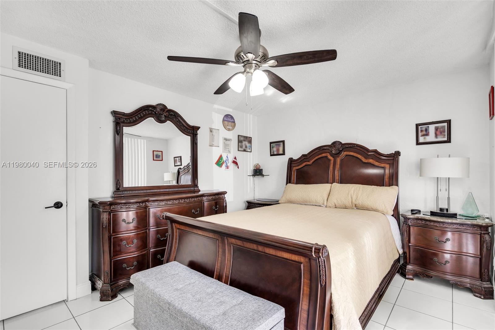 8405 Northwest 8th Street, Unit 1072 Miami, FL 33126 - Photo 21 of 33 a bedroom with a bed and a chandelier