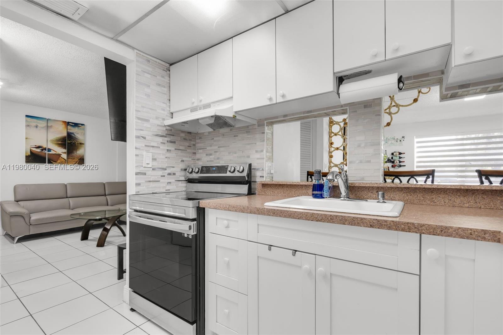 8405 Northwest 8th Street, Unit 1072 Miami, FL 33126 - Photo 23 of 33 a kitchen with stainless steel appliances granite countertop a sink and cabinets