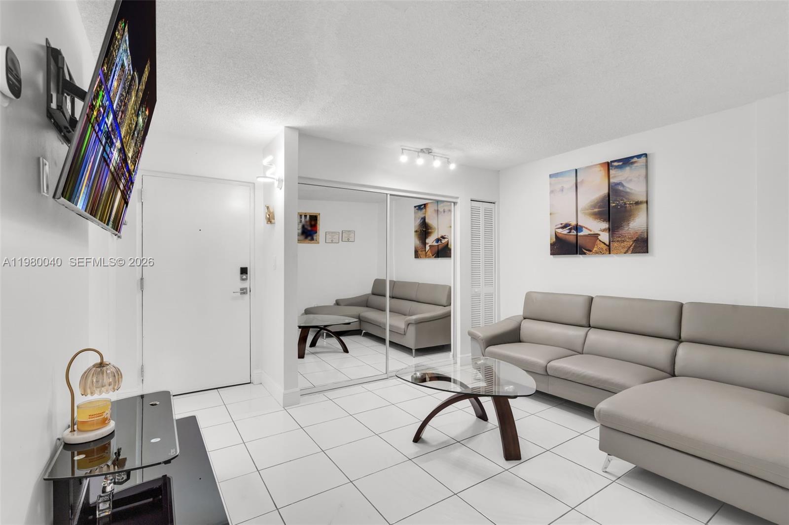 8405 Northwest 8th Street, Unit 1072 Miami, FL 33126 - Photo 27 of 33 a living room with furniture a rug and a potted plant