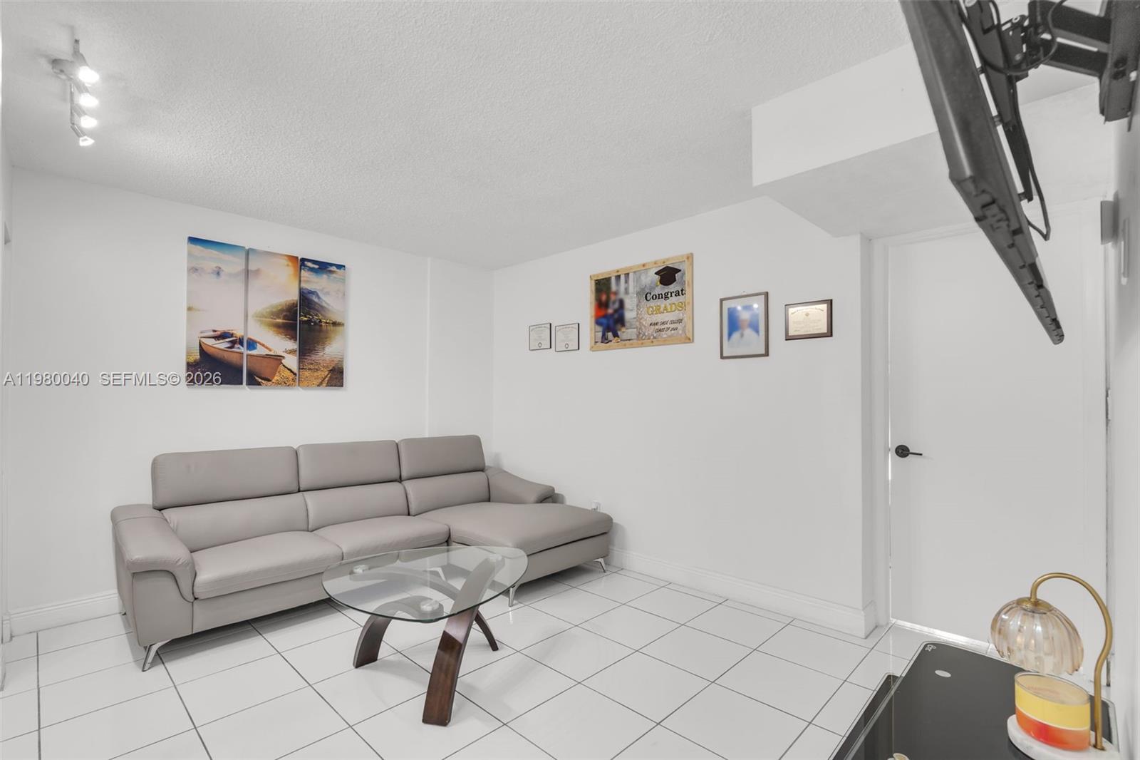 8405 Northwest 8th Street, Unit 1072 Miami, FL 33126 - Photo 30 of 33 a living room with furniture and rug