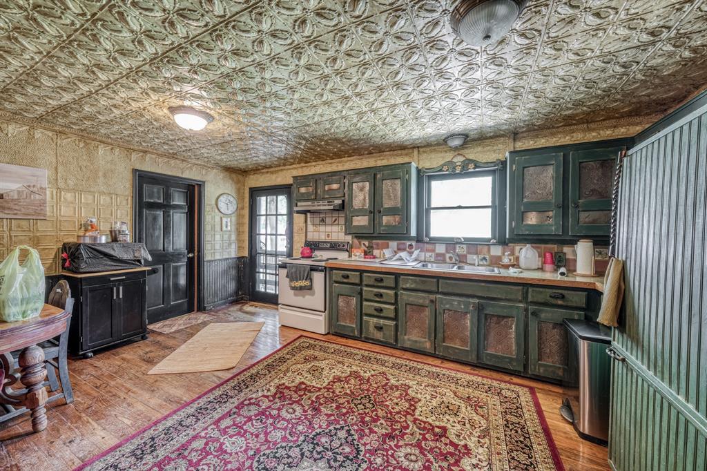 8601 Star Hollow Road Lipan, TX 76462 - Photo 14 of 40 a kitchen with stainless steel appliances granite countertop a stove a sink and a refrigerator