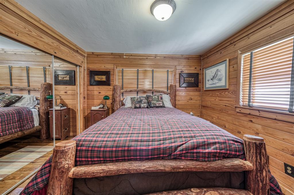 8601 Star Hollow Road Lipan, TX 76462 - Photo 18 of 40 a bedroom with a large bed and a large window