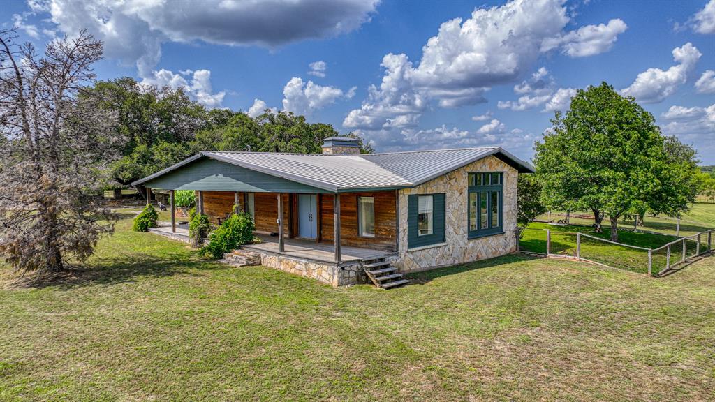 8601 Star Hollow Road Lipan, TX 76462 - Photo 3 of 40 a front view of a house with garden