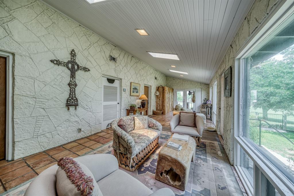 8601 Star Hollow Road Lipan, TX 76462 - Photo 8 of 40 a living room with furniture and a floor to ceiling window