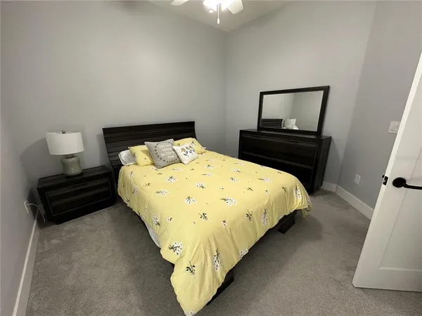 a large bed sitting in a bedroom next to a window