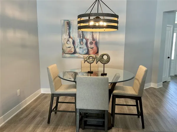 a dining room with furniture and wooden floor