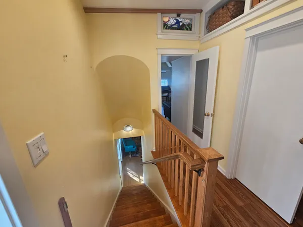 a view of a hallway view with wooden floor and furniture