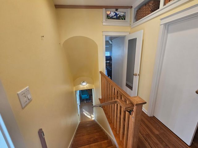 a view of a hallway view with wooden floor and furniture