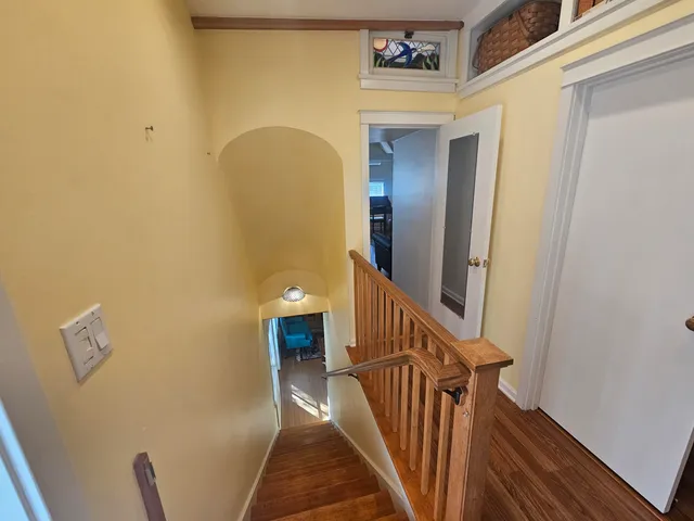 a view of a hallway view with wooden floor and furniture