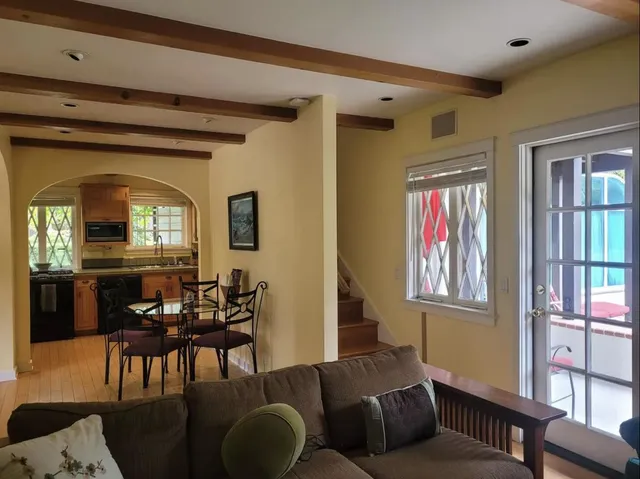 a living room with furniture a dining table and a window