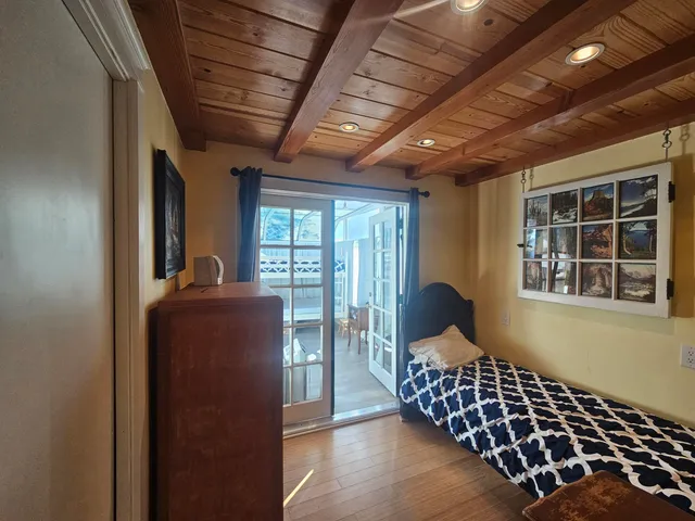 a view of a chairs and table in the back yard of a building