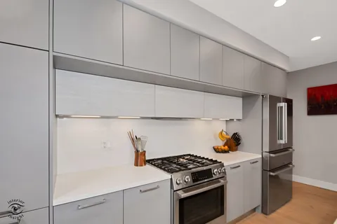 a kitchen with stainless steel appliances and cabinets