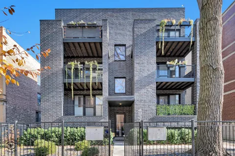 front view of a brick house with a small yard