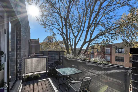 a view of a backyard with chairs and a fire pit
