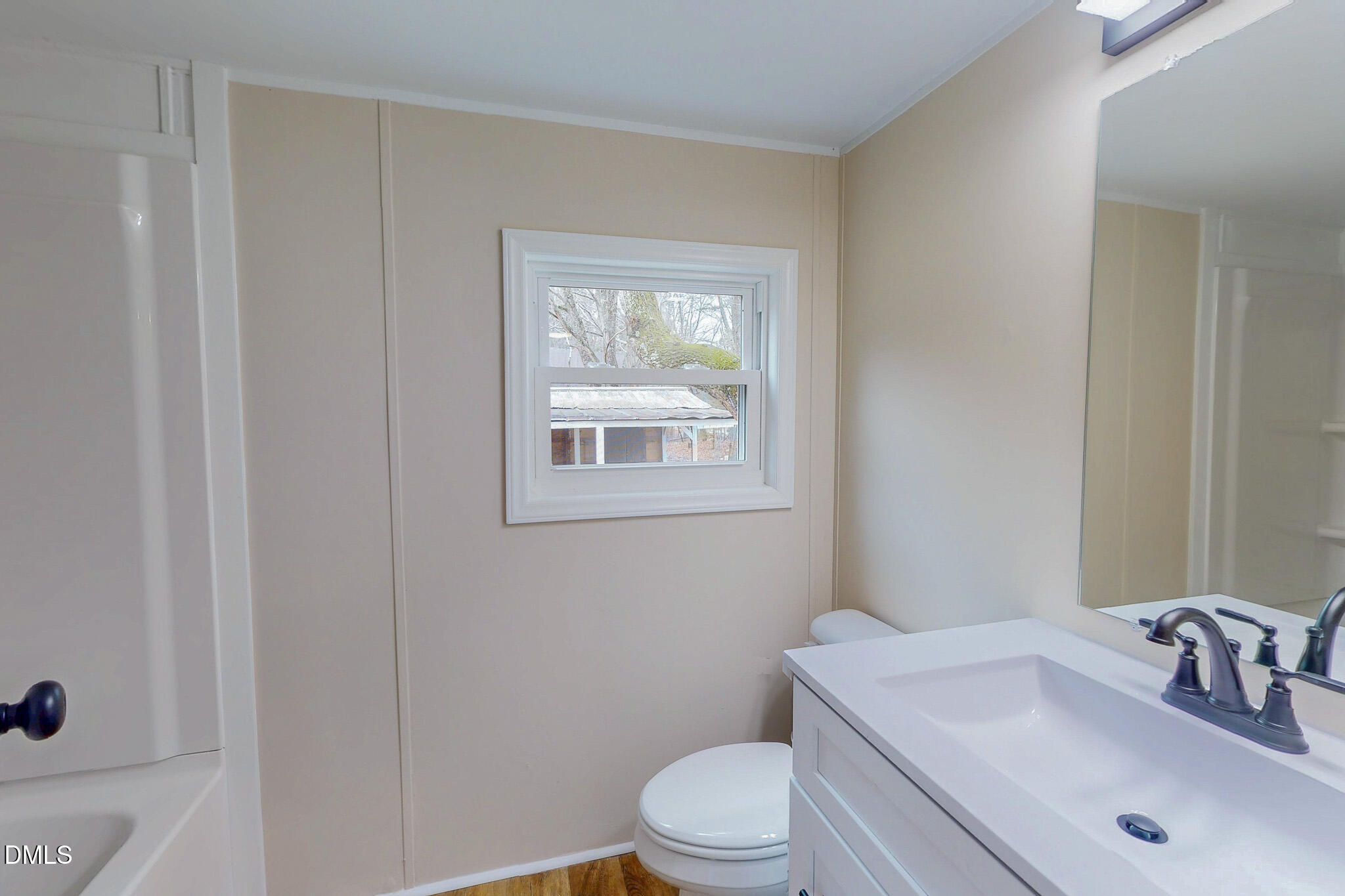 67 Halifax Road Roxboro, NC 27574 - Photo 18 of 48 a bathroom with a toilet a sink and mirror