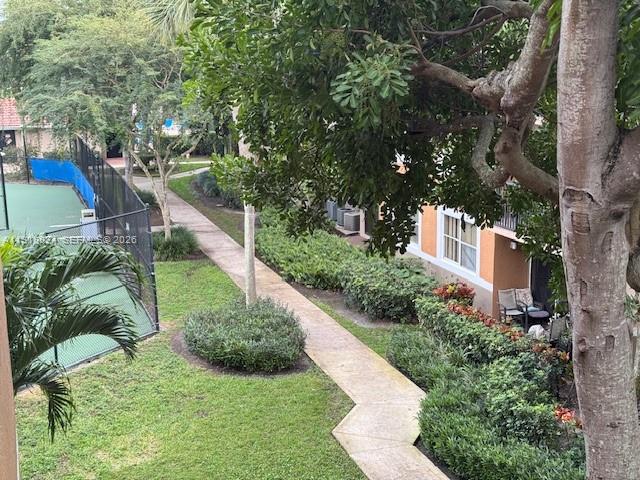 8801 Wiles Road, Unit 307 Coral Springs, FL 33067 - Photo 16 of 16 a view of a garden with plants and large trees