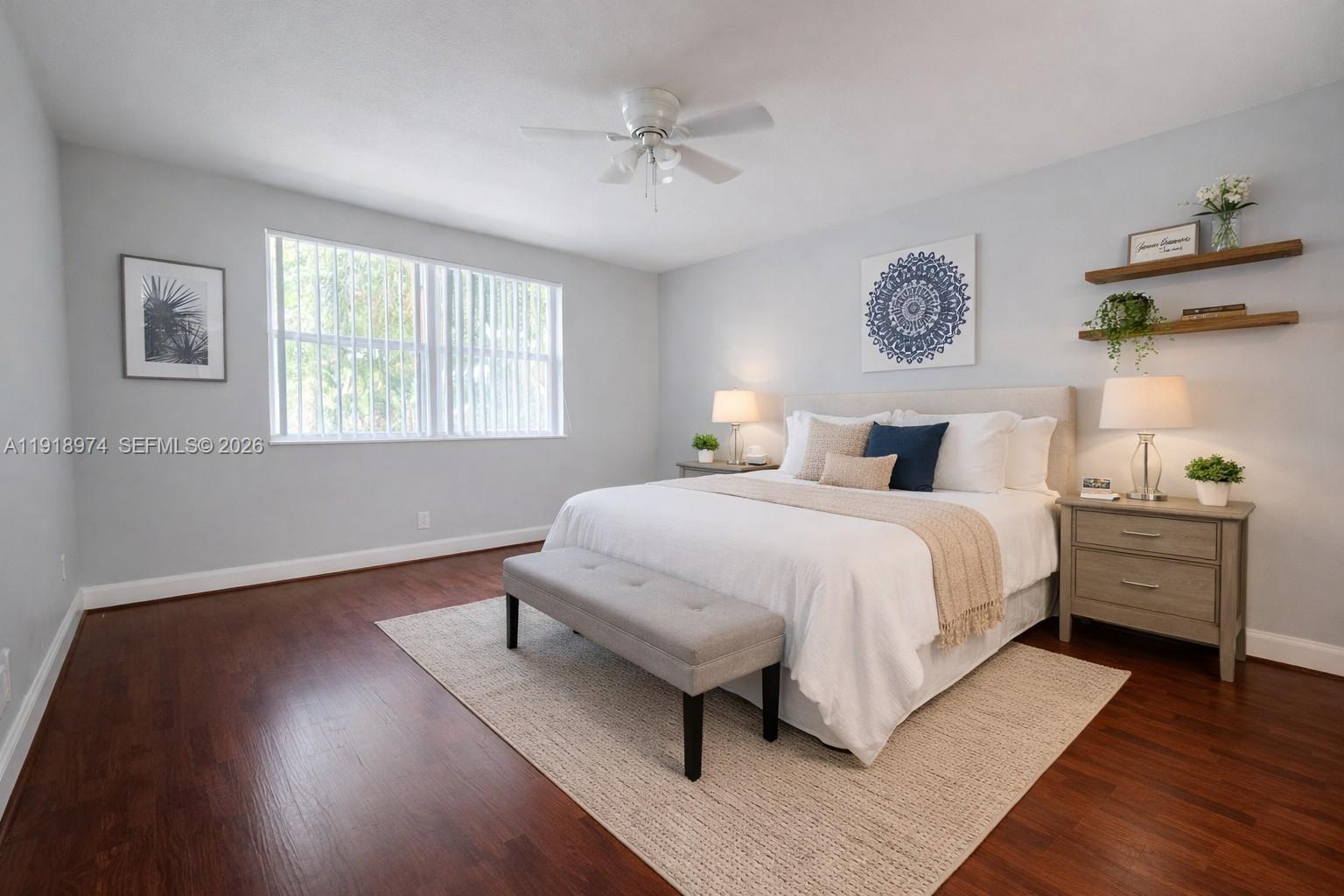 8801 Wiles Road, Unit 307 Coral Springs, FL 33067 - Photo 7 of 16 a bedroom with a bed and a window