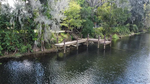 a wooden bench sitting next to a lake
