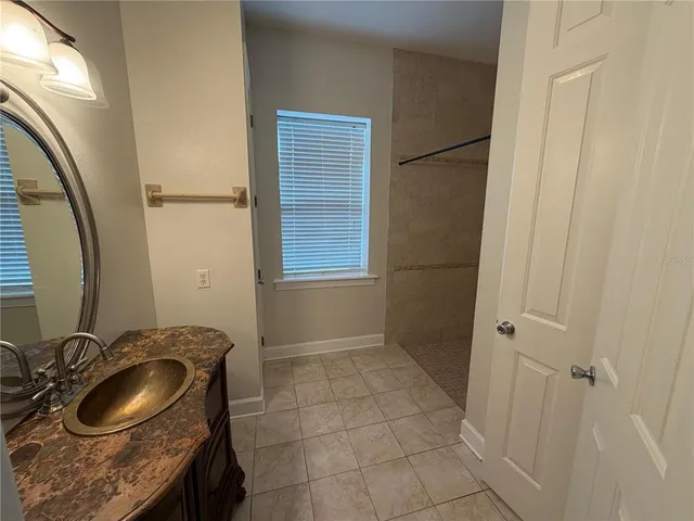 a kitchen with a sink a counter space and a dining table