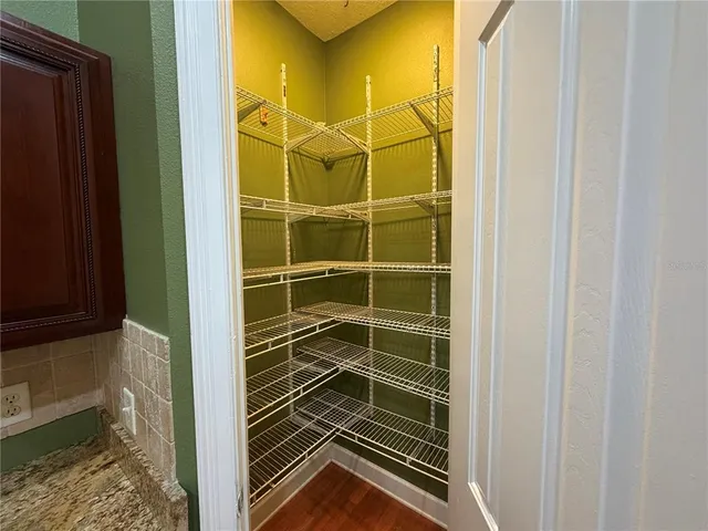a view of a hallway with furniture and window